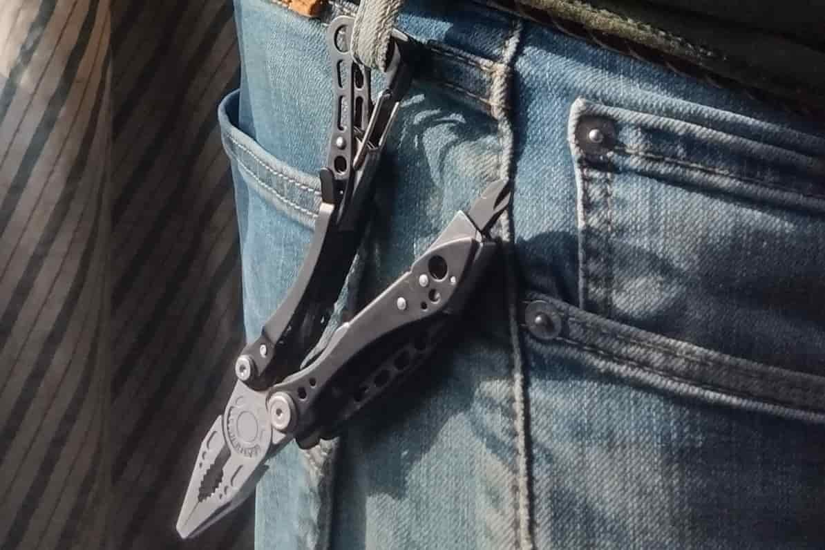 The Leatherman Skeletool clipped to a belt loop.