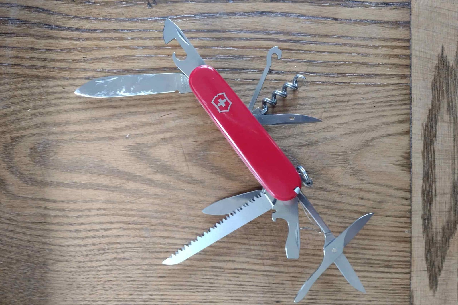 The Victorinox Huntsman, resting on a board, with its tools deployed.