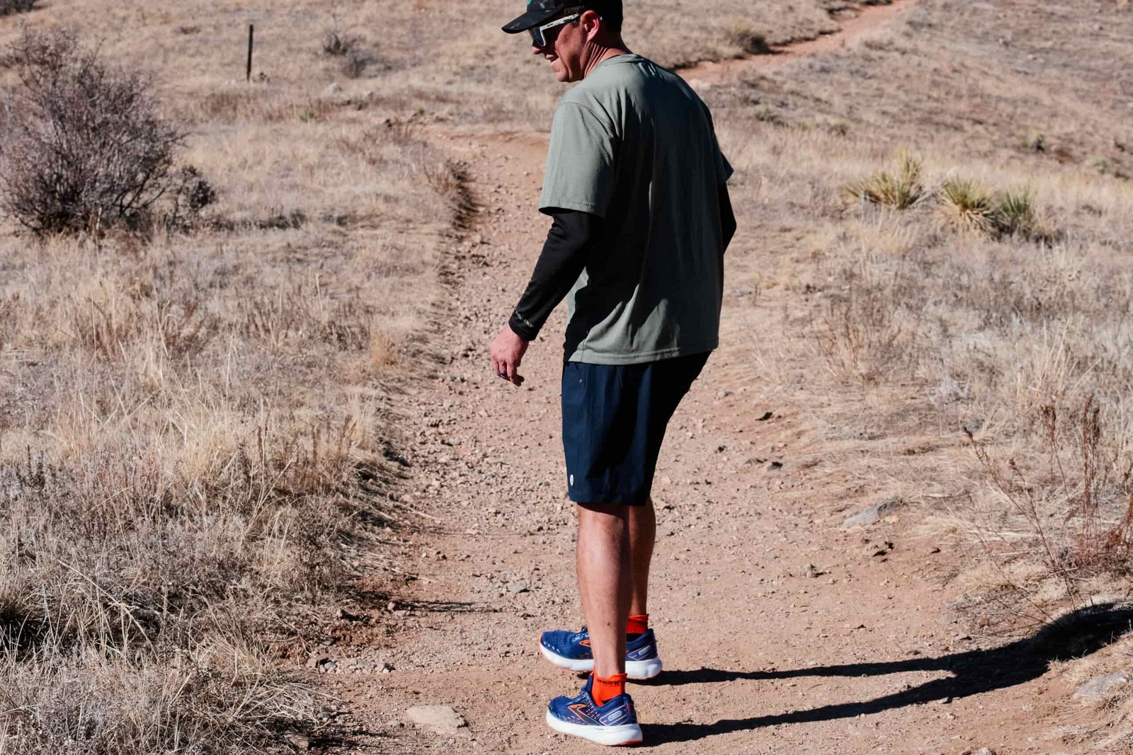 A man looks off to the side while hiking.