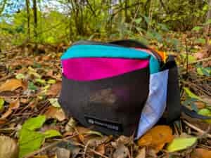 a view of the atom pack's roo fanny pack resting on the ground