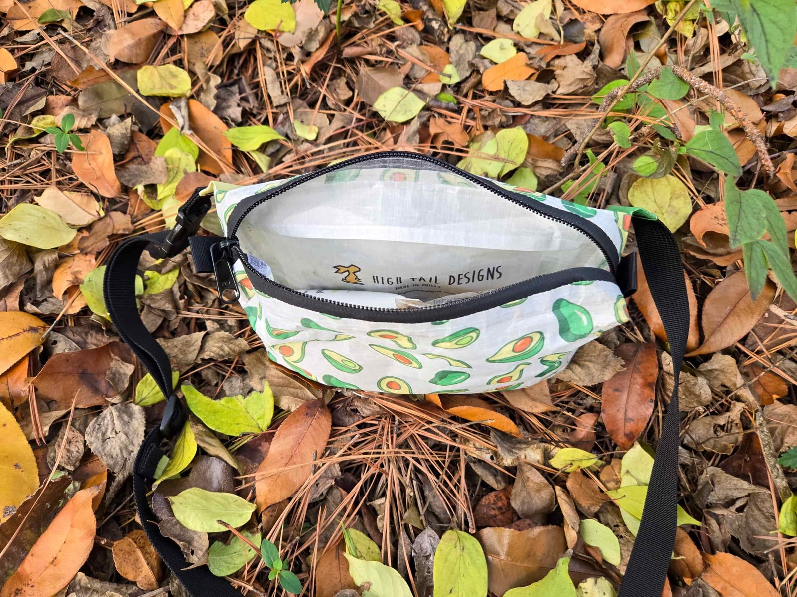 the ultralight fanny pack by high tail designs unzipped and empty on a leafy ground