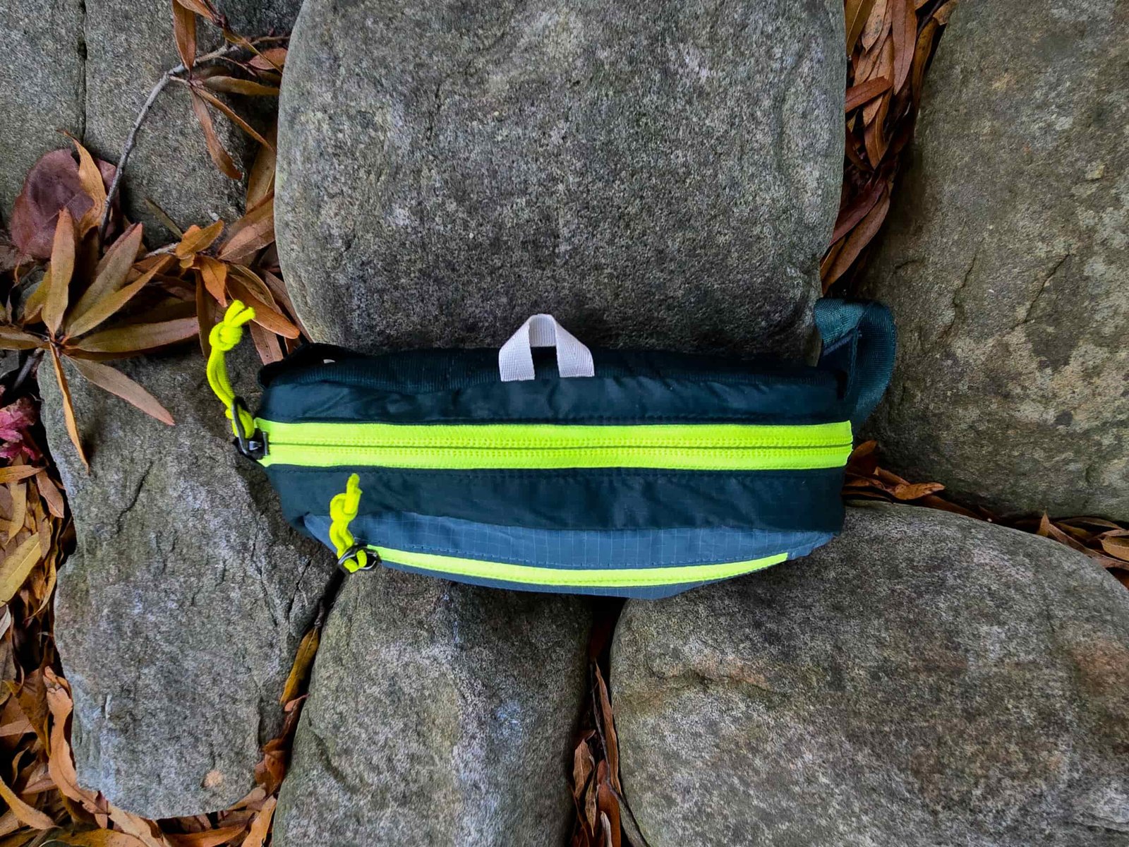 the view of the top of the patagonia black hole mini hip pack with its two zippered compartments