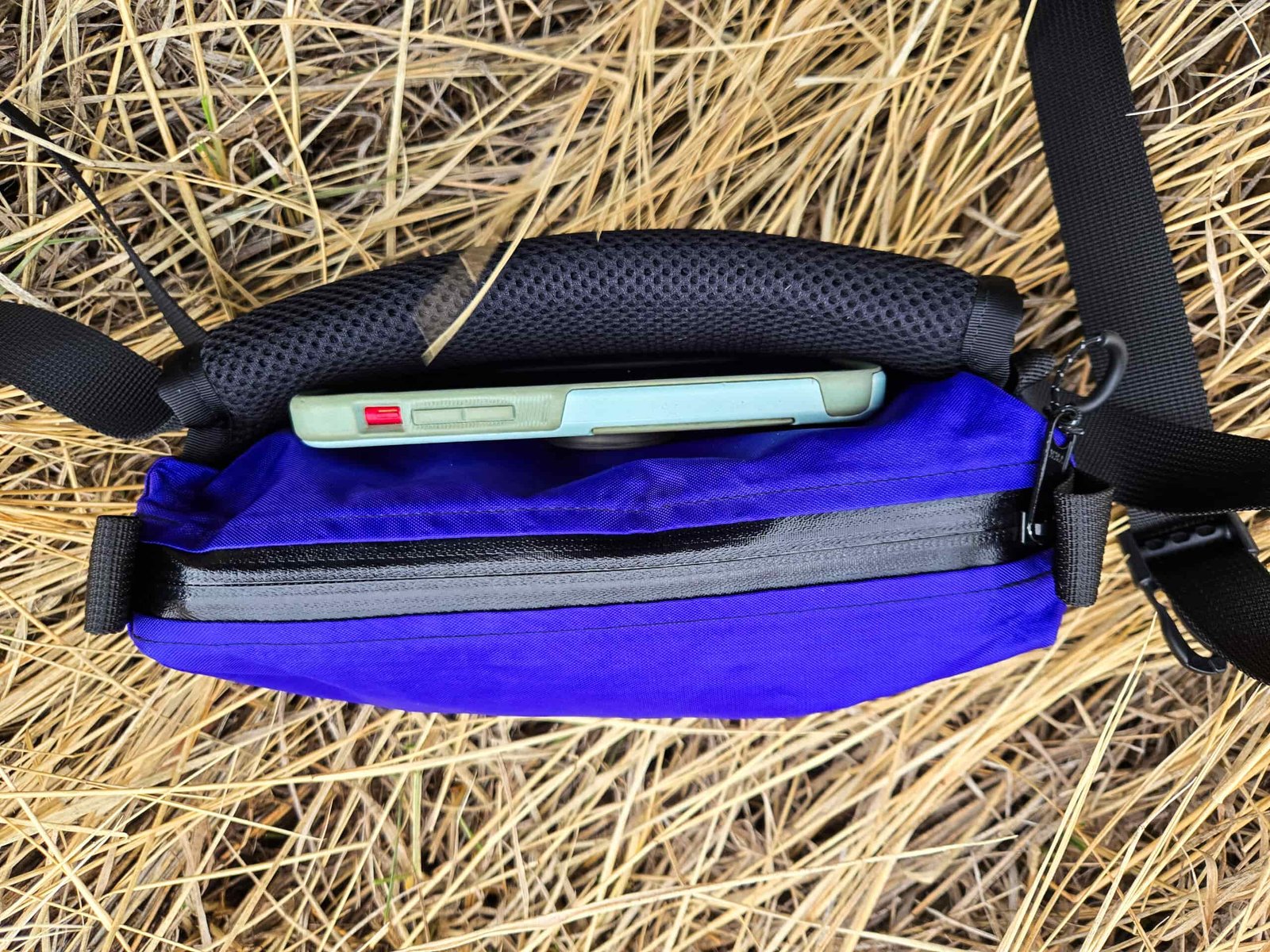 view of a filled thrupacks summit bum fanny pack resting on the ground
