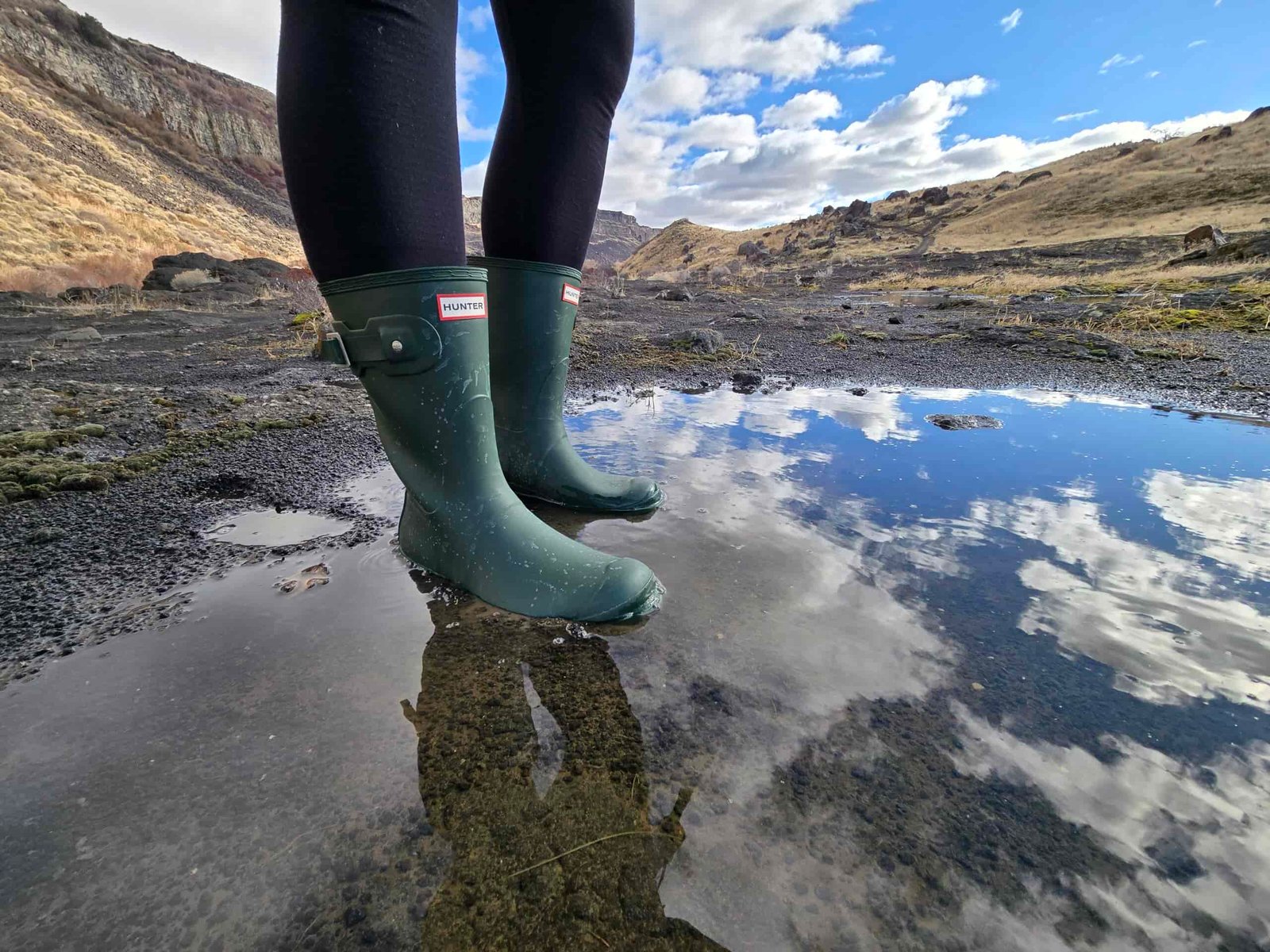 woman's legs wearing hunter original short boots