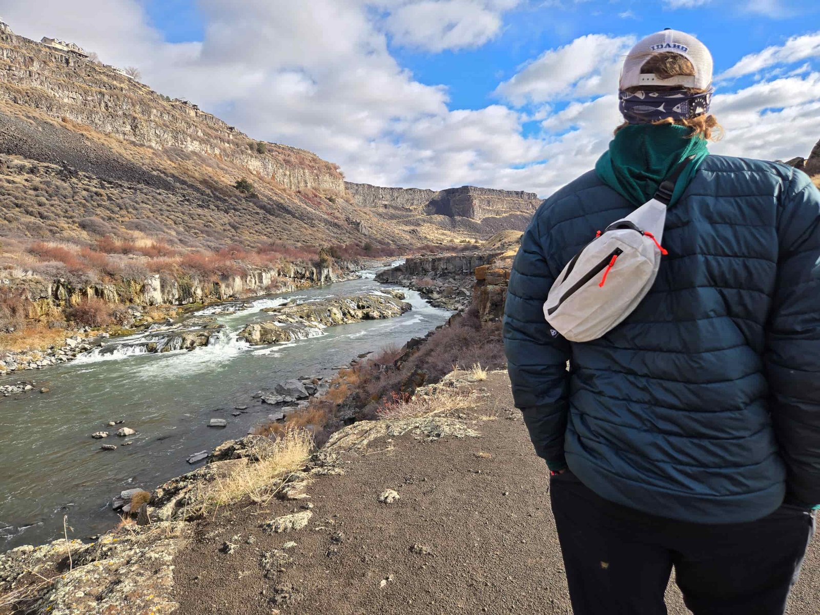 man walking along a river wearing a versa fanny pack