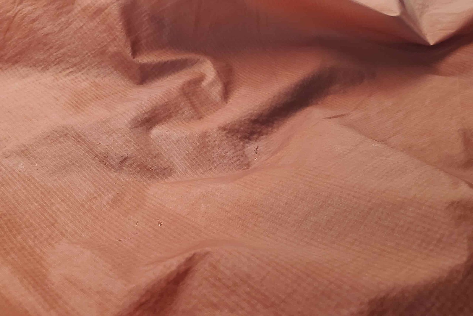 A closeup of sweat trapped on the underside of a windbreaker.