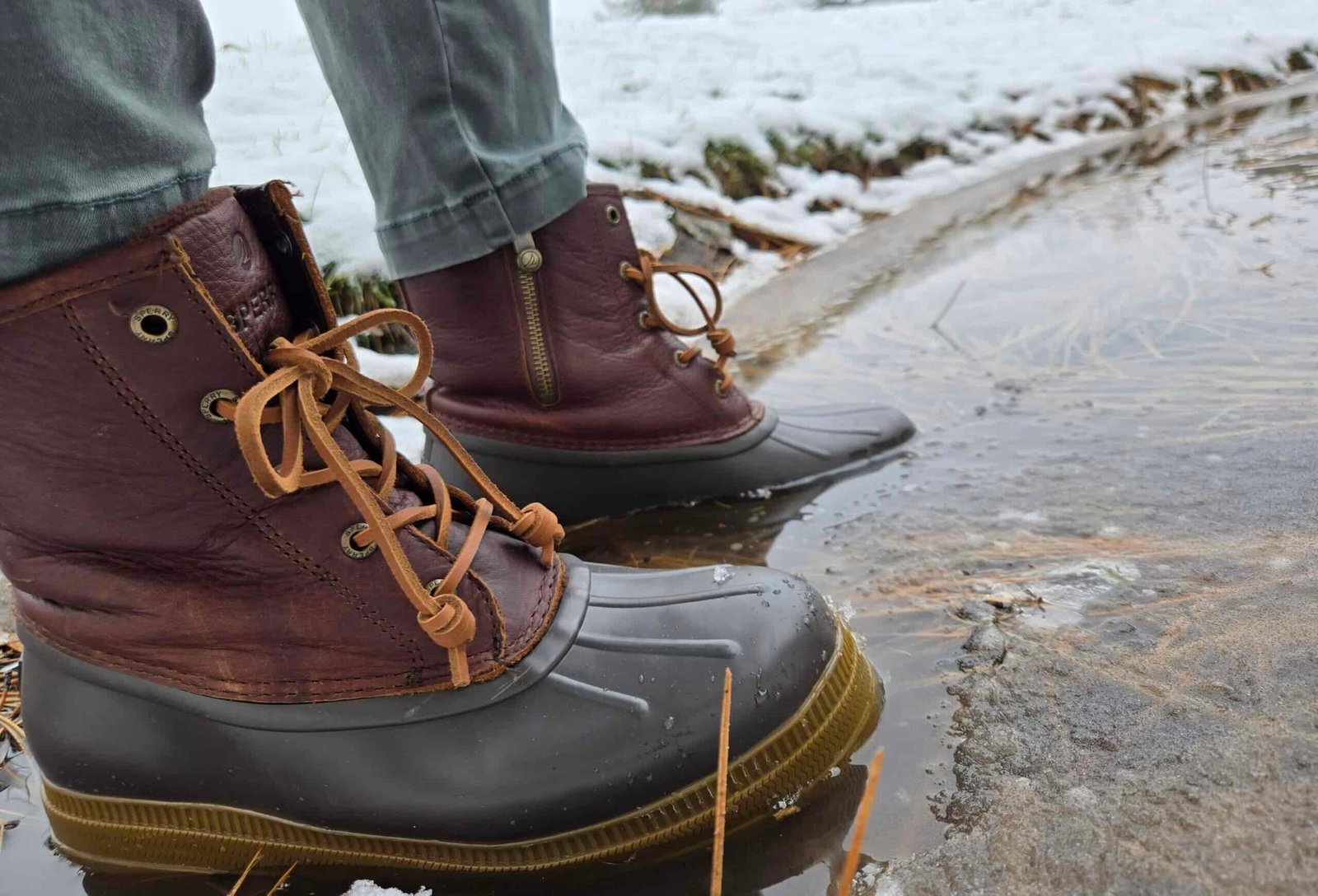 a woman wearing the sperry saltwater 2.0 in a pond