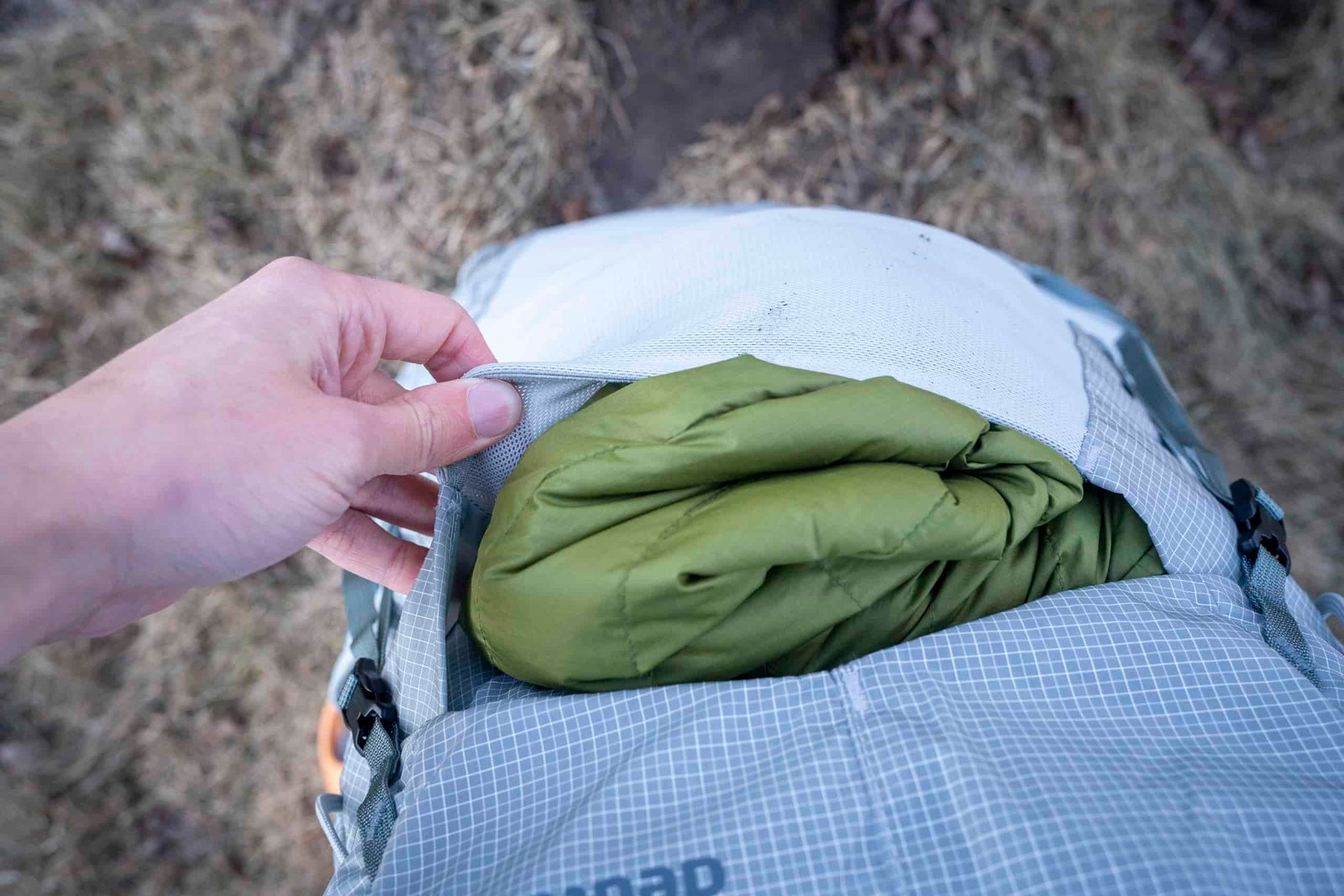 a jacket in a backpack pocket