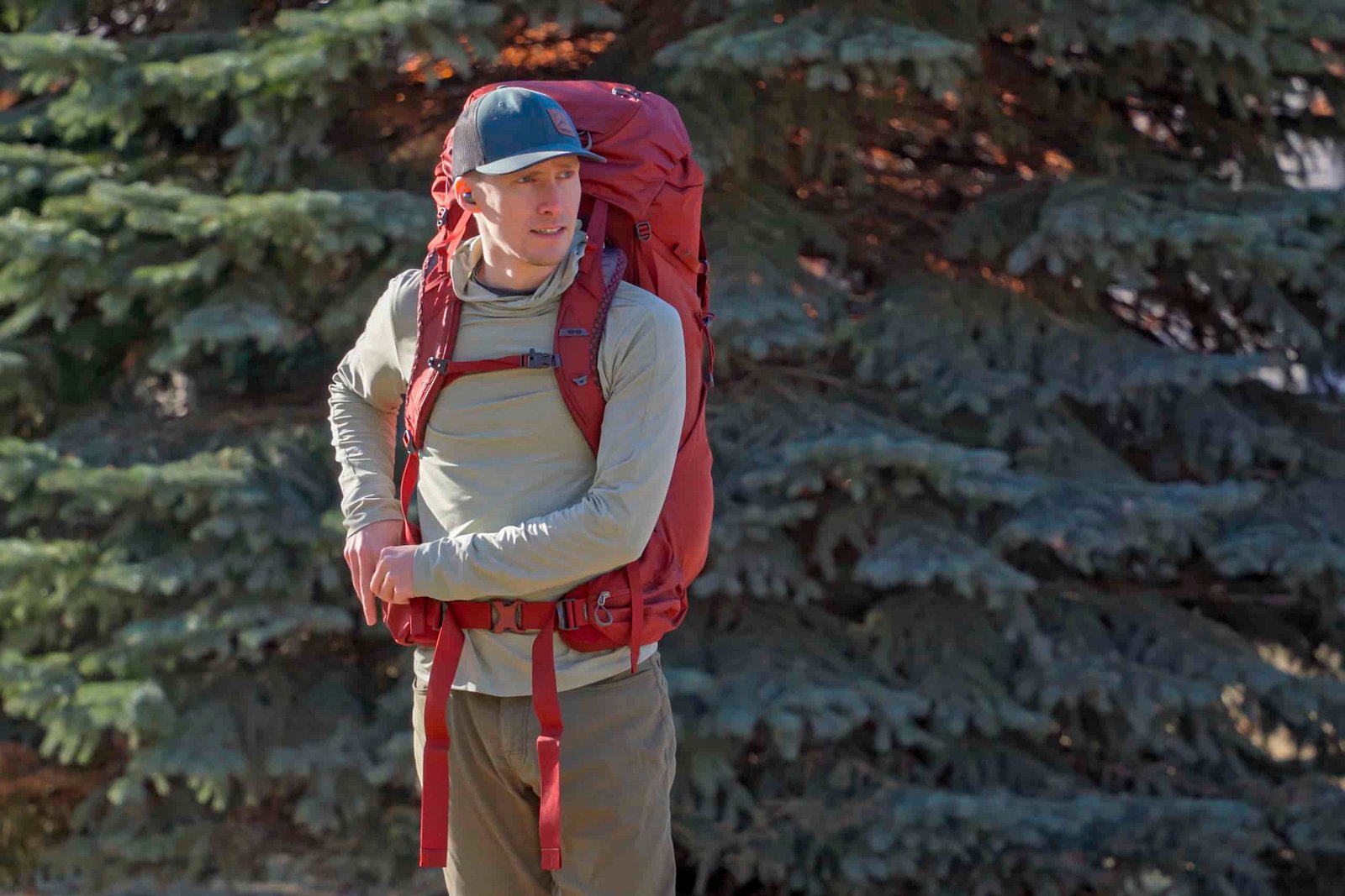 a man wears a red backpack