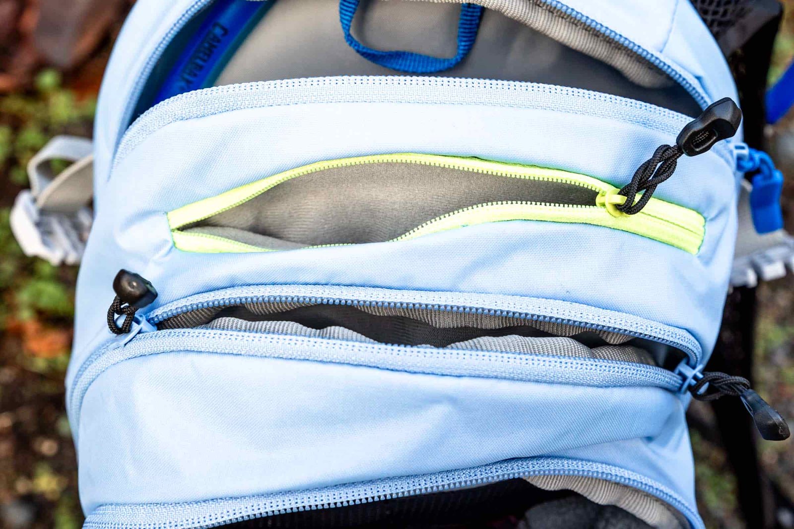 Details of M.U.L.E.® 12 Hydration Pack 100 oz - a view of the compartments of the pack from the top with all the zippers open 