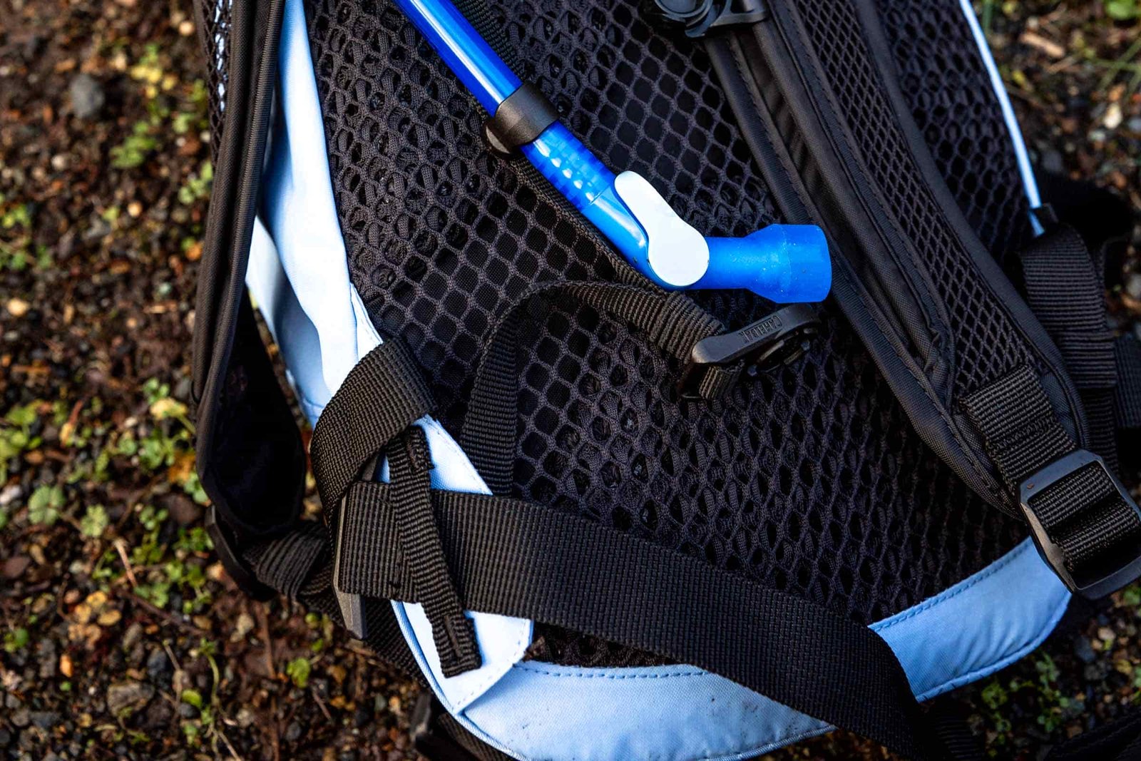 Details of M.U.L.E.® 12 Hydration Pack 100 oz - a photo of the back of the pack showing the hydration hose and shoulder straps