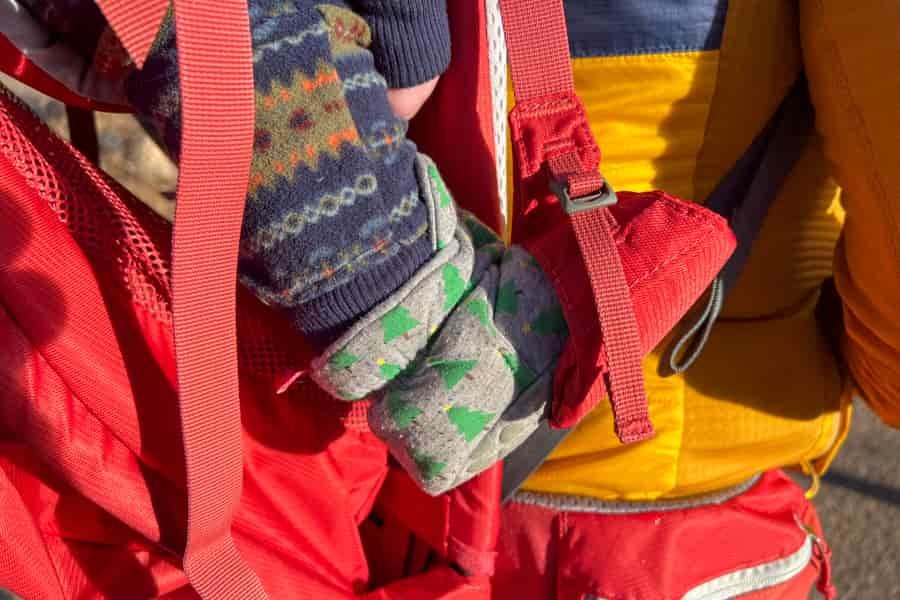 A babies foot in a stirrup of a deuter backpack
