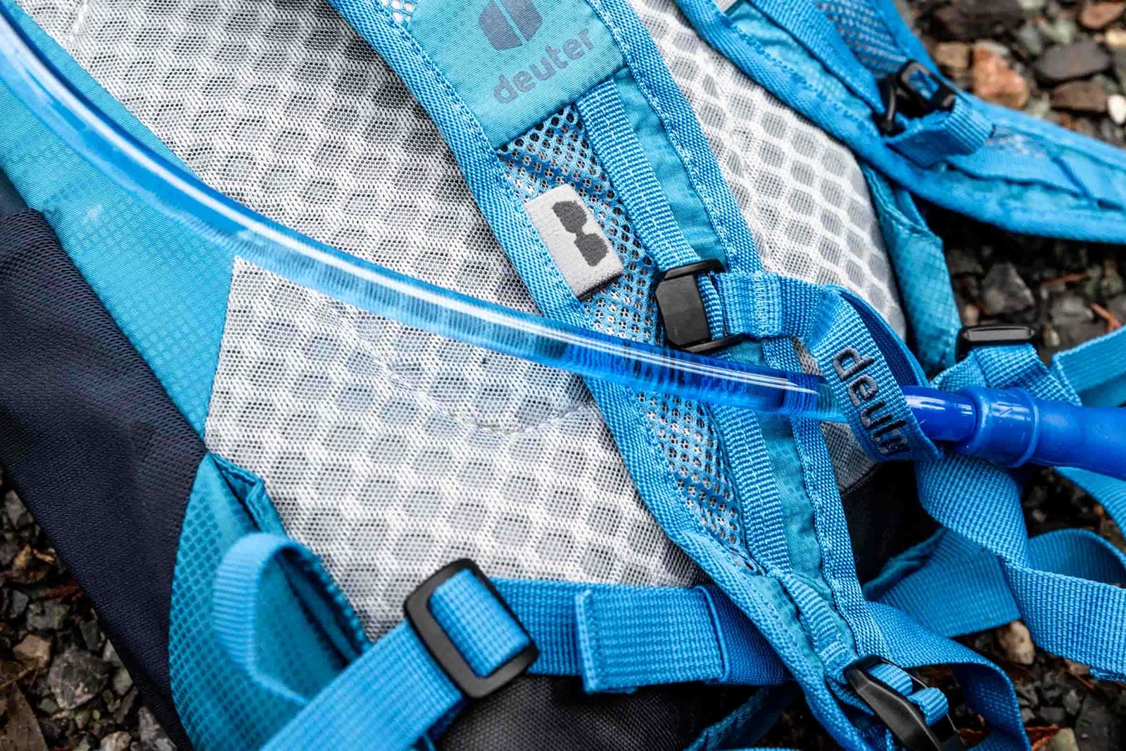 Details of Deuter Speed Lite 13 Hydration Pack - back view of the pack showing the buckles and shoulder straps and back padding and the hydration hose is in sight