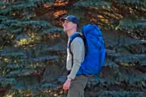 a man wears a blue backpack