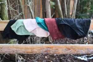 Six pairs of the women's hiking underwear tested laid out on a fence