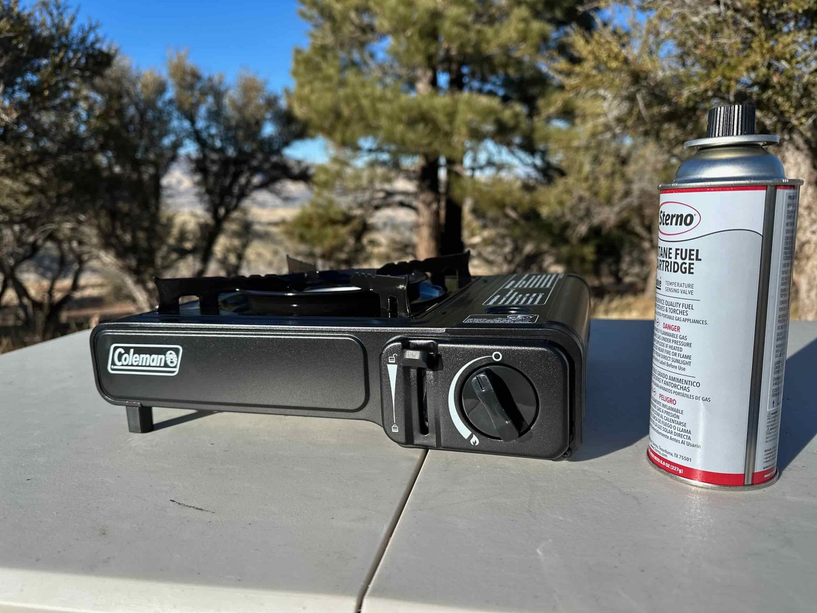close ups of the Coleman Classic 1-Burner Butane Camping Stove in an camp site in the pines