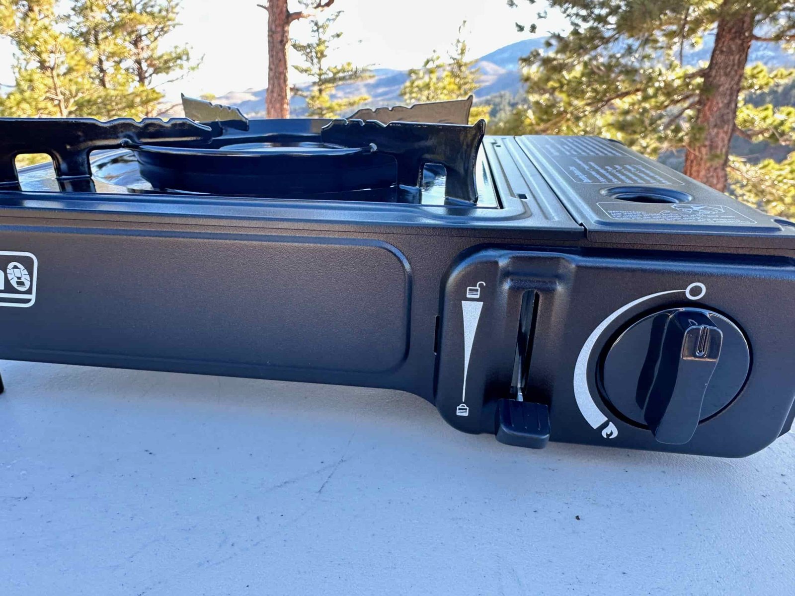 close ups of the Coleman Classic 1-Burner Butane Camping Stove in an camp site in the pines