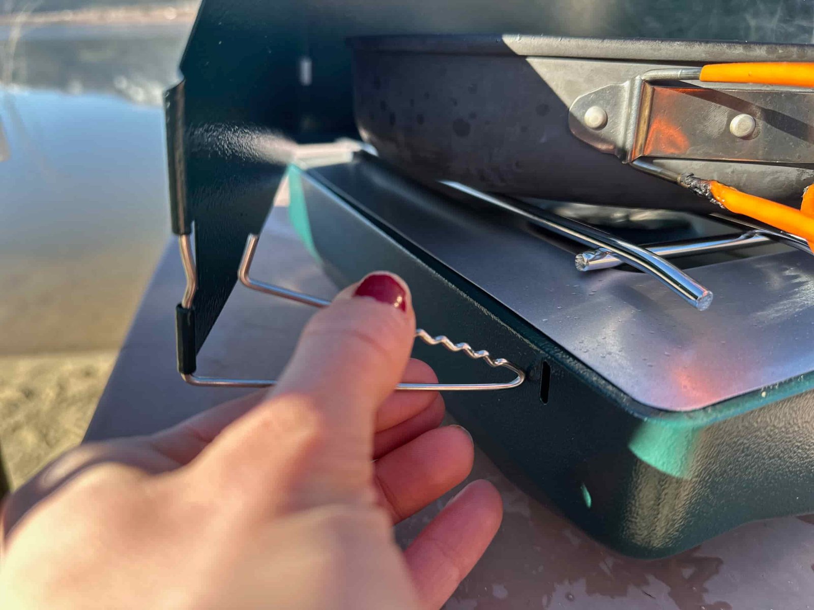the Coleman Cascade Classic 2-Burner cooking camp meals at a beachside camp