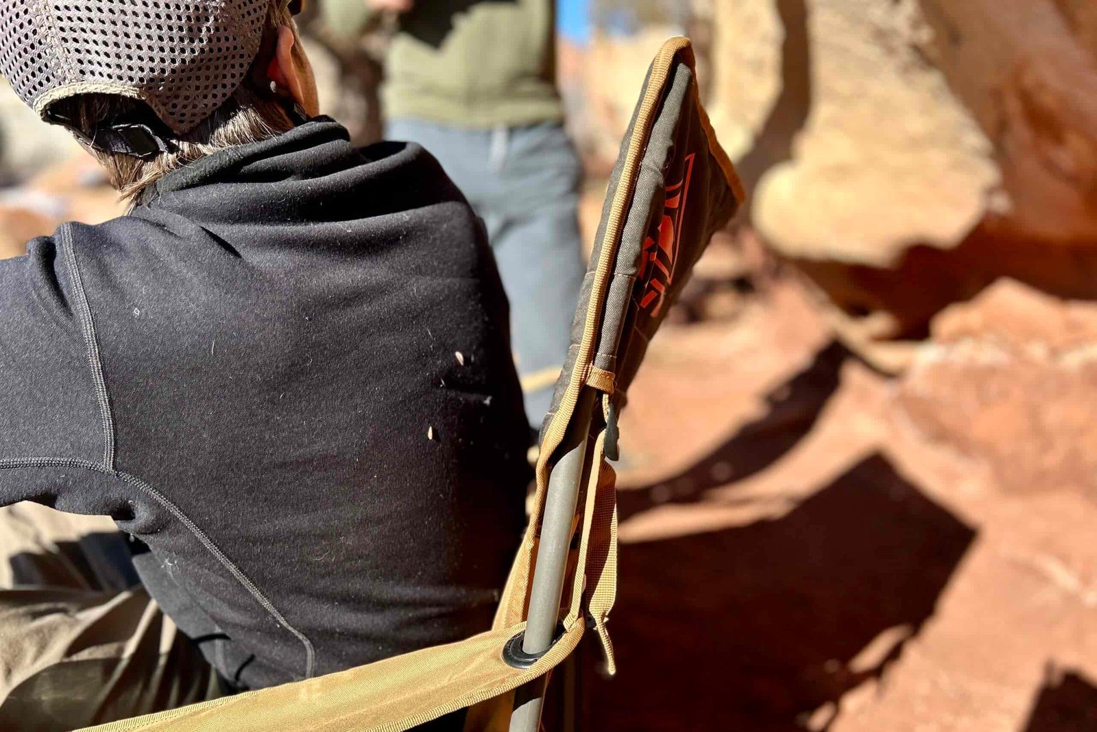 Close up of the back of a camping chair from the side.