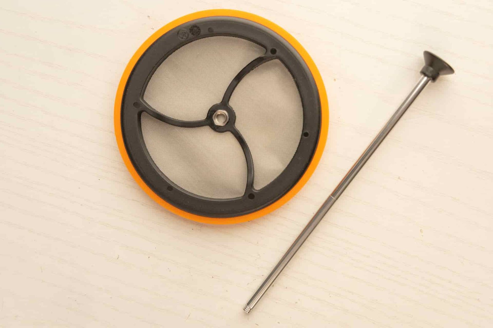 The Jetboil Silicone Coffee Press in two parts: the filter disconnected from the plunger arm.