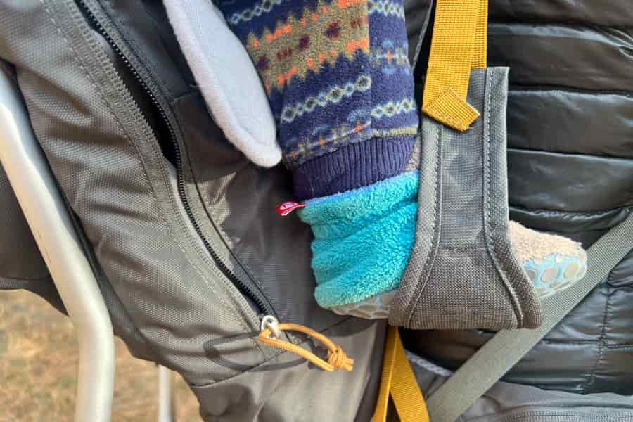 Close-up of a child’s foot resting in the foot stirrup of the Kelty PerfectFIT Journey Elite.