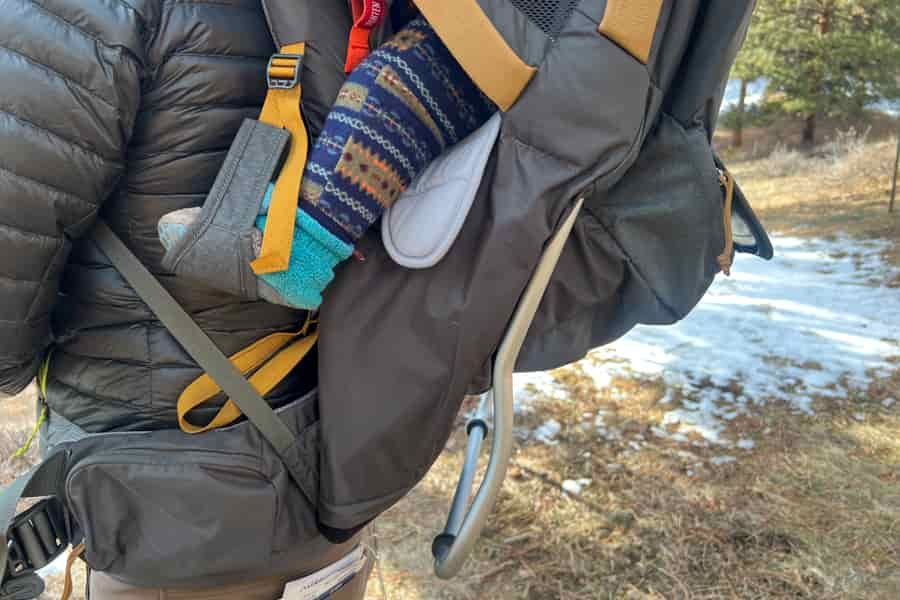 Side view showing the child foot support on the Kelty PerfectFIT Journey Elite carrier.