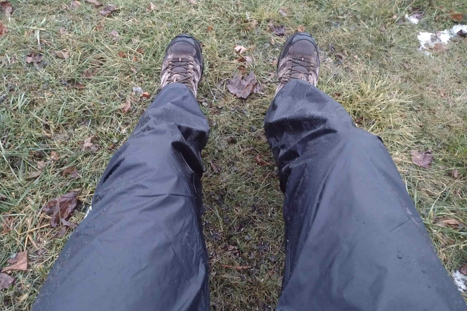 Closeup of a person wearing the Montbell Versalite rain pants.