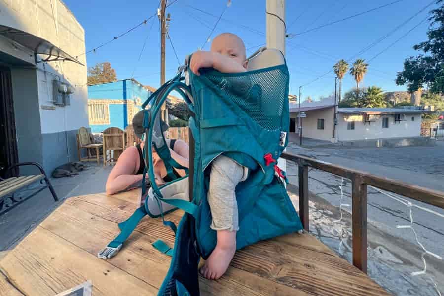 Close-up side view of the Osprey Poco SLT child carrier, highlighting the baby’s mesh seat and comfortable design.