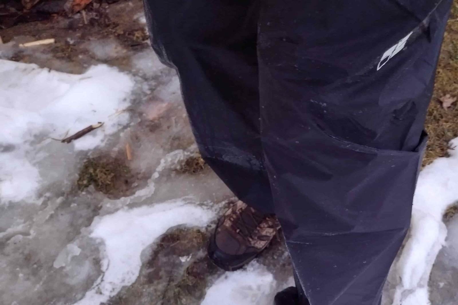Closeup of a person wearing the Montbell Versalite rain pants.