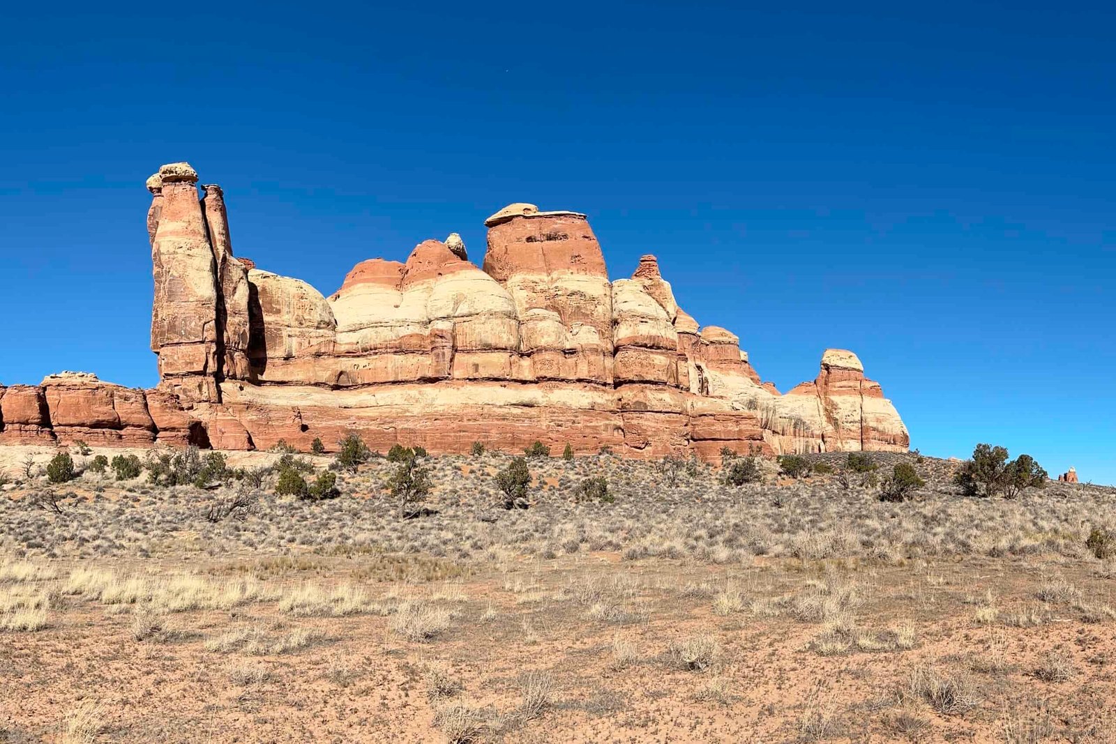 Towering red rocks on a cloudless day in Canyonlands National Park