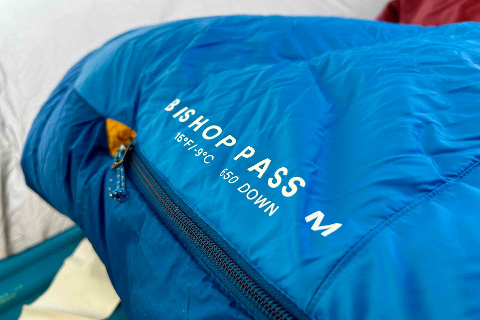 Close-up image of a sleeping bag with text printed on the bag that reads "BISHOP PASS 15F / -9C 650 DOWN".