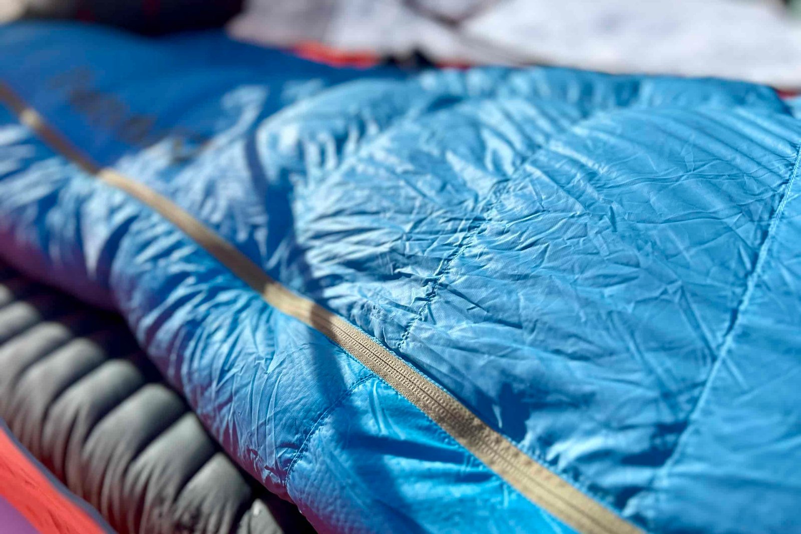 Close up image of the texture of a sleeping bag with the zipper up.
