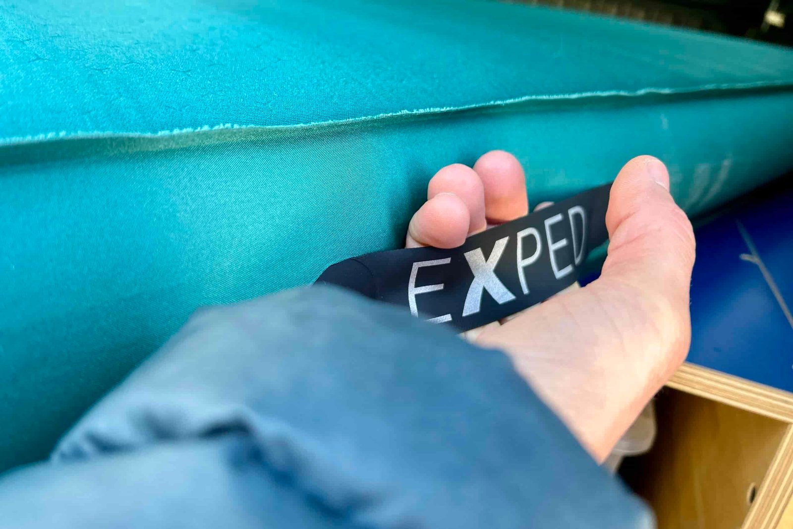 Close-up image of a handle on the side of a camping mattress.