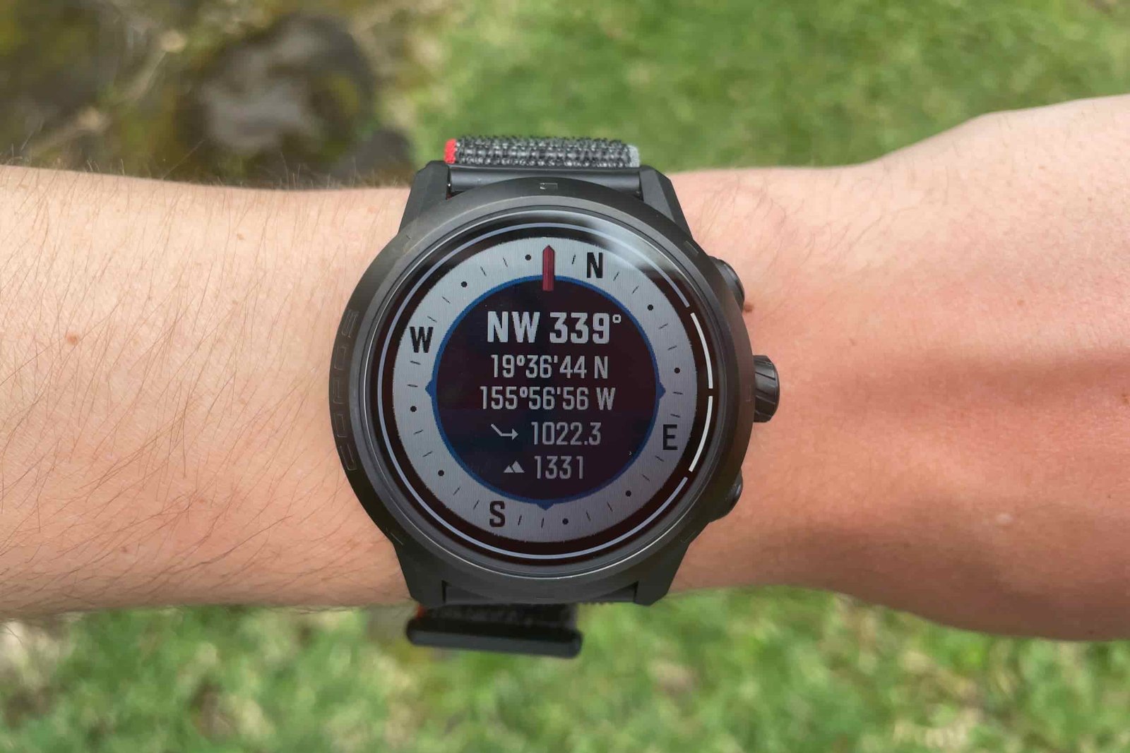 A closeup of the compass on a watch face.