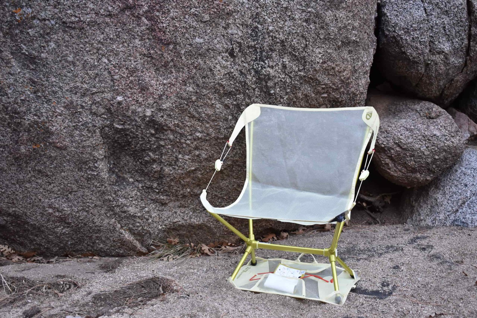 NEMO Moonlite chair sits on its included ground sheet in a sandy desert wash