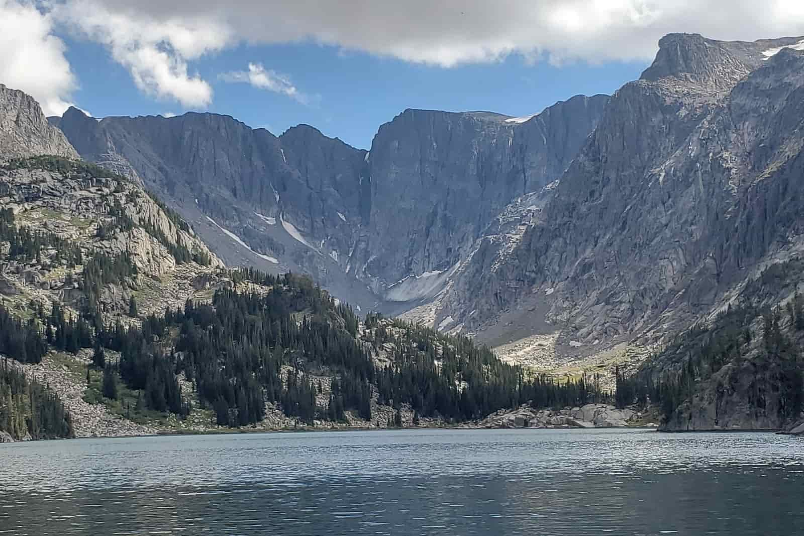An alpine lake with a small glacier in the background.