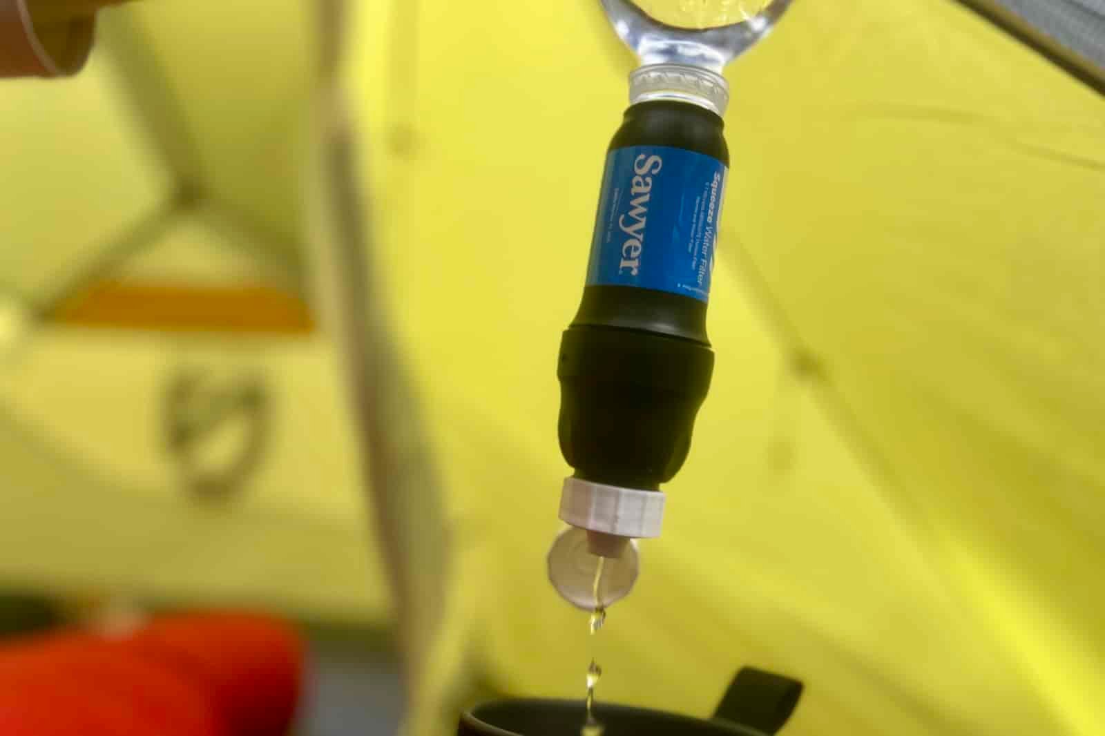 a close up of water being squeezed through the sawyer squeeze