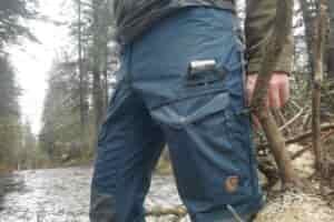 A closeup of a unique pocket on a pair of pants.