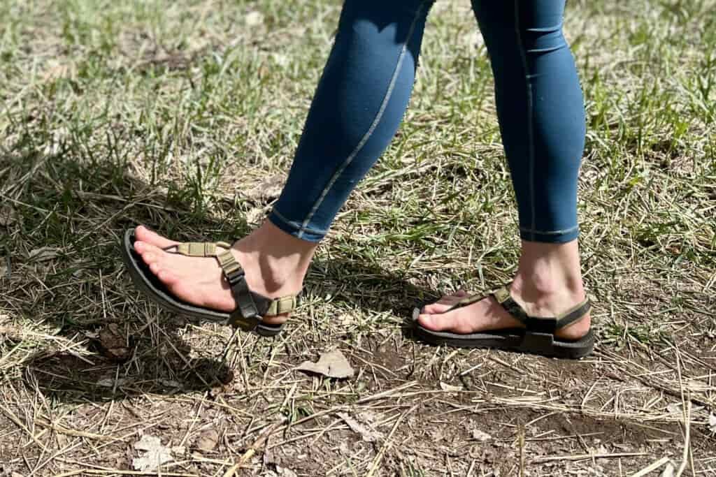 Profile image of a person walking in sandals and leggings in a grassy setting.