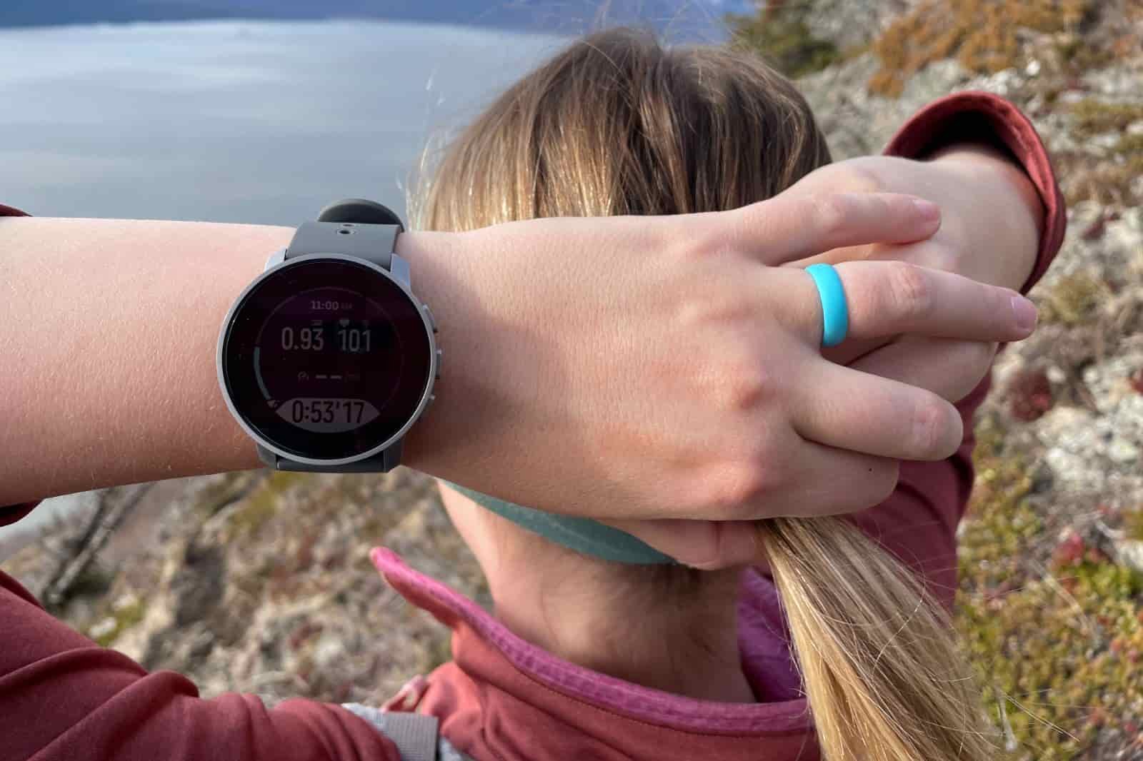 A closeup of a GPS watch worn on a woman's wrist.