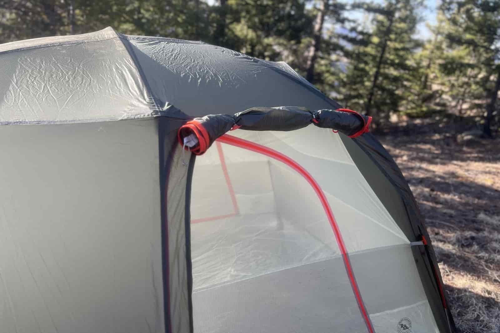 a close up of the awning door rolled up on a tent