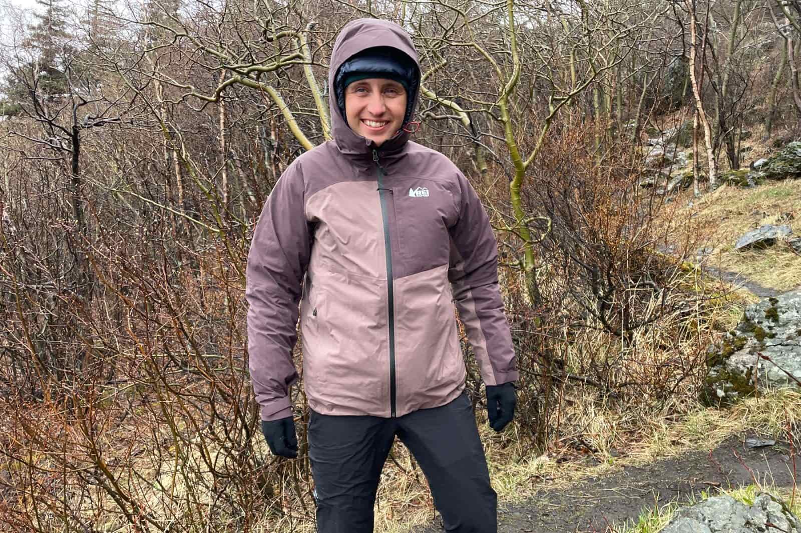 A man hikes in the rain on a trail