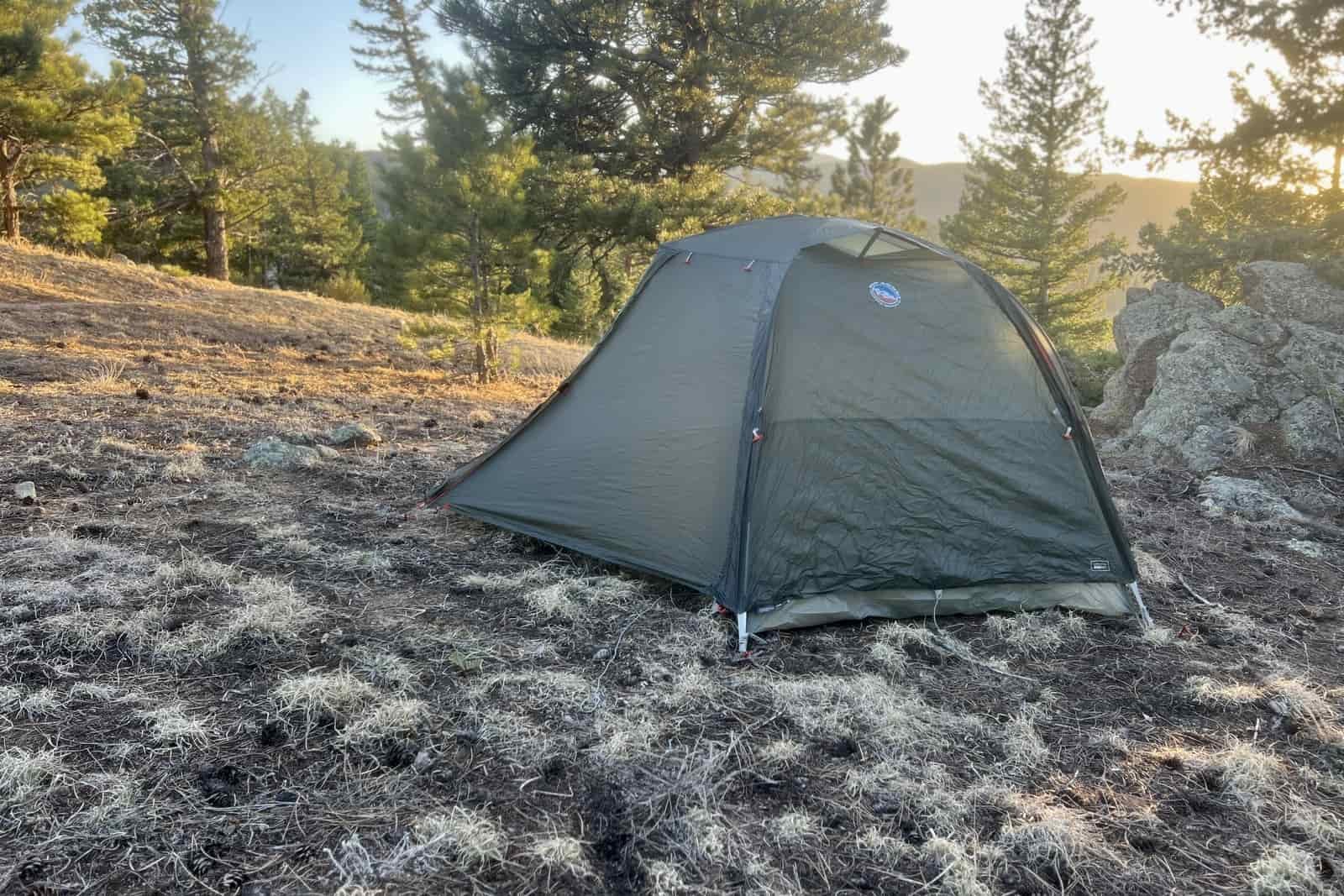 a big agnes tent sits pitched in a forest