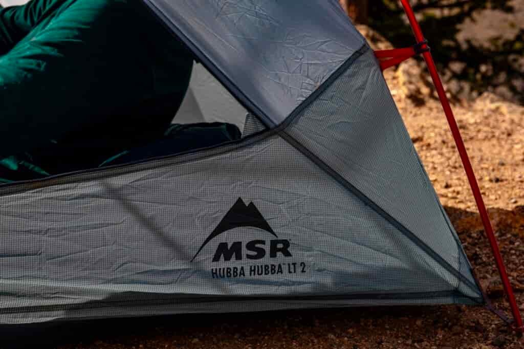 a close up of the corner of a tent reading "msr hubba hubba LT 2"