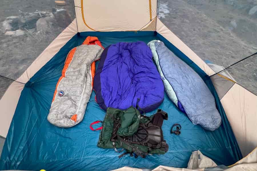 A view from above of the interior of a tent. Camping gear is layed out inside the tent.