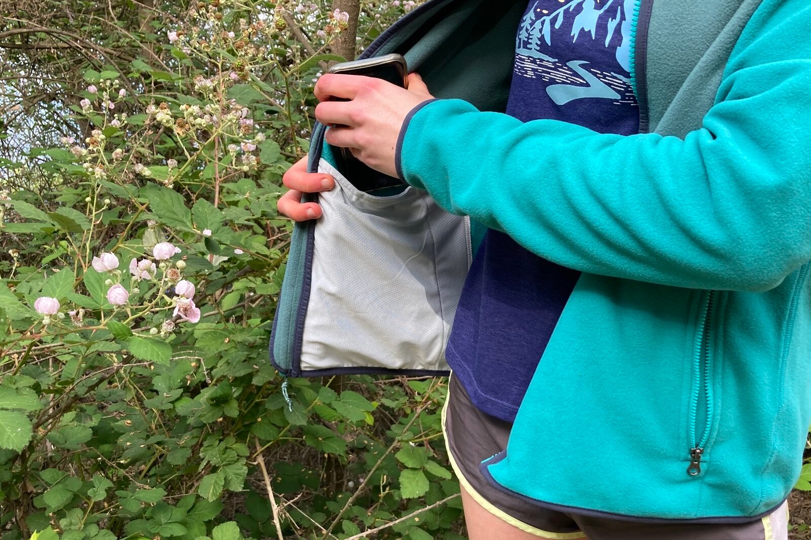 Close up showing the interior mesh pocket of a fleece jacket.