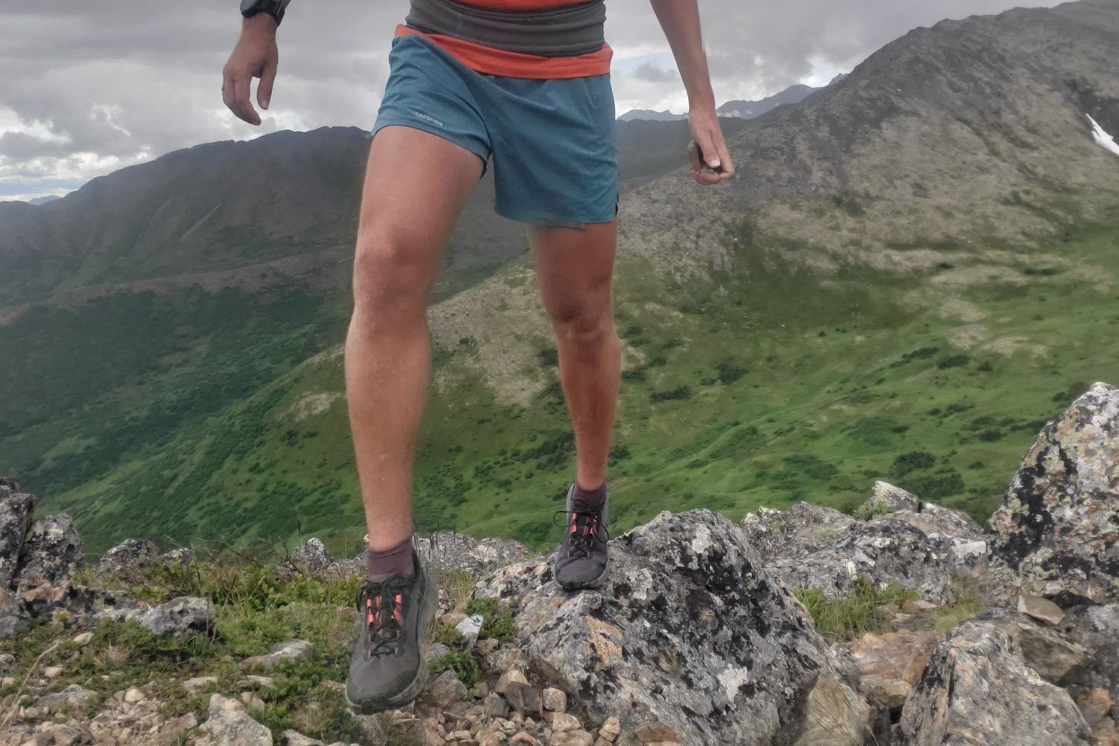 A man hikes on a rocky summit