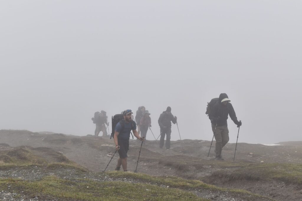 A group of hikers in the fog on an eerie mountain top