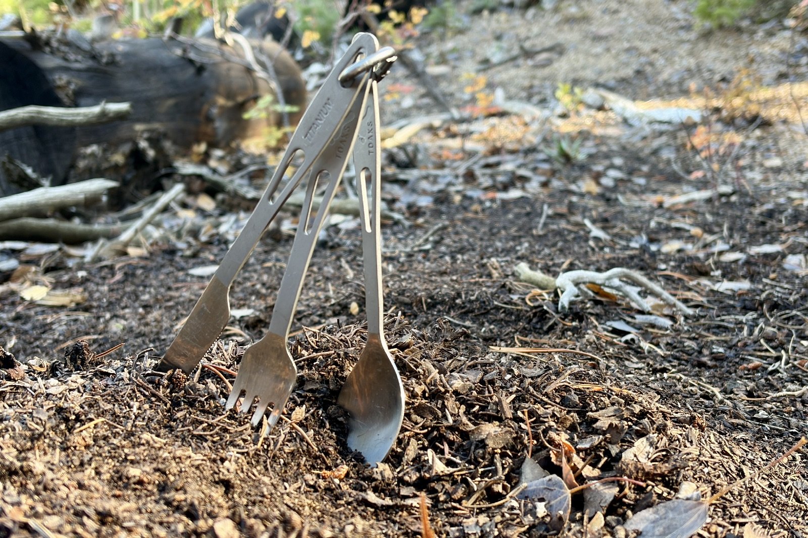a 3-piece cutlery set stabbed in dirt