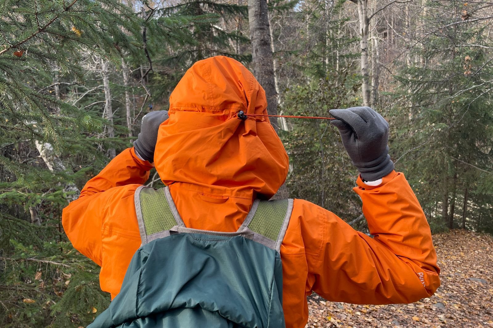 A closeup of the hood of a jacket being tightened.